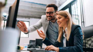 two business people create a disaster recovery plan at computer